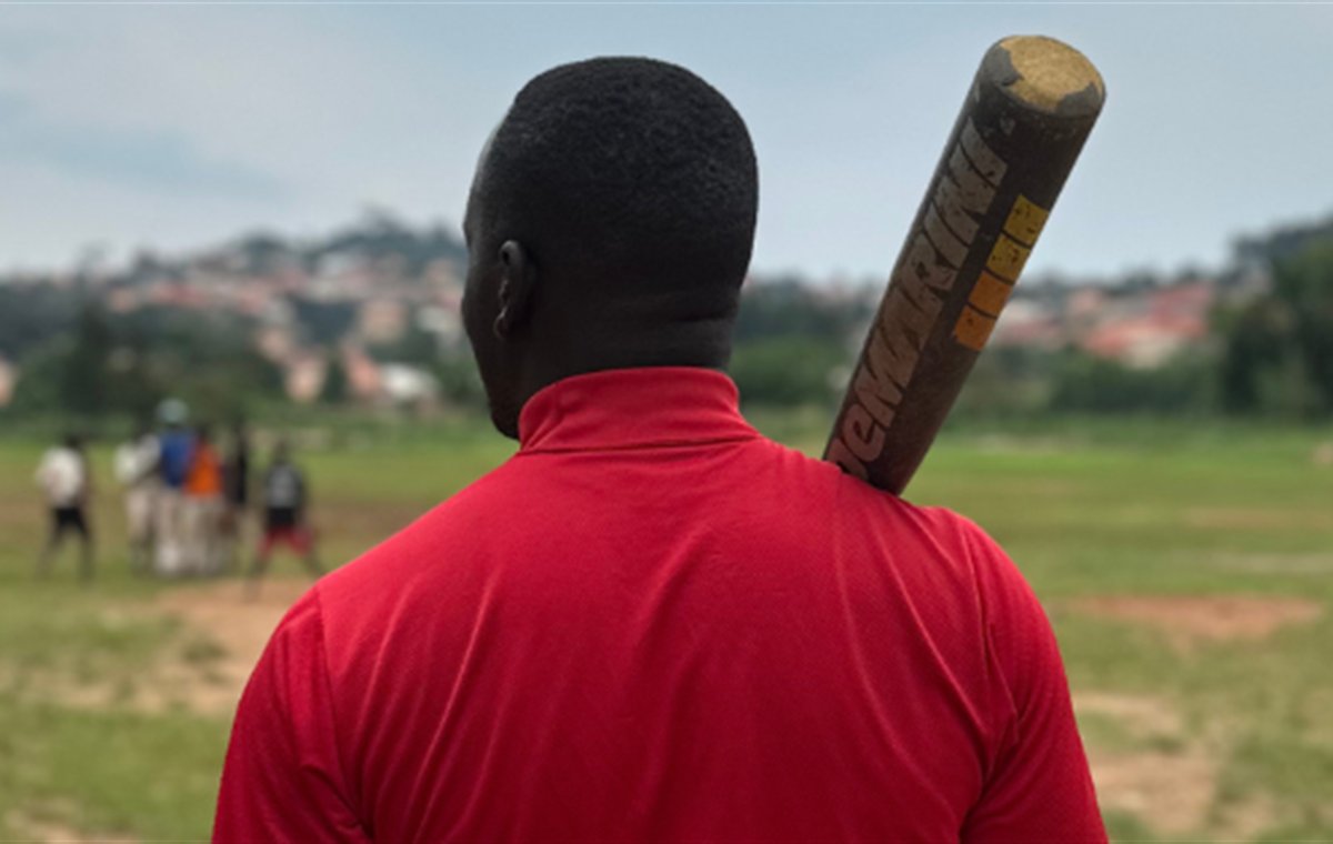 Uganda Koshien players gathered on a baseball field